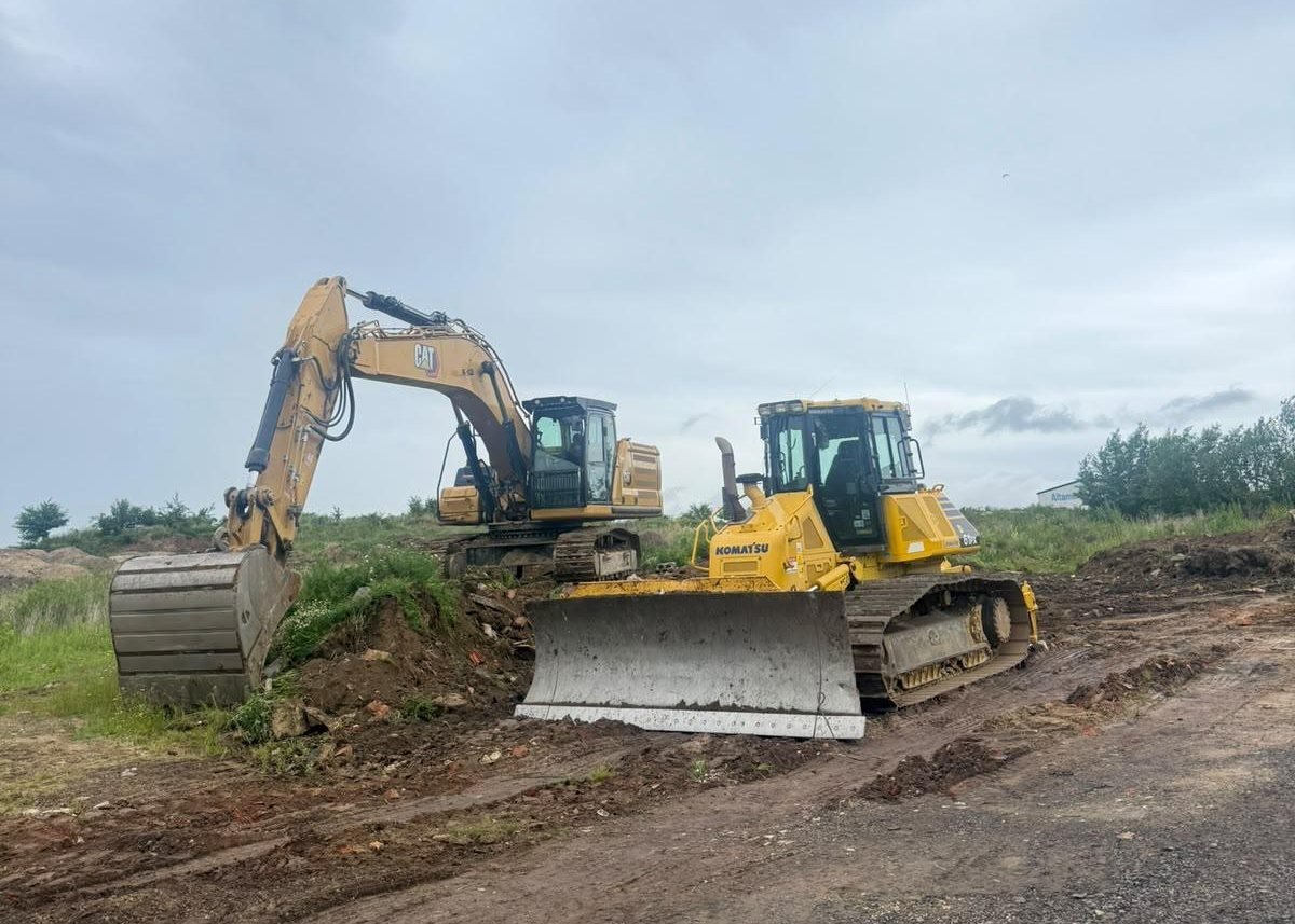 Pásové rypadlo a dozer Komatsu při přípravě pláně